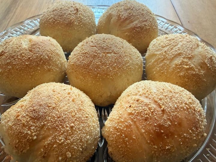 Round pandesal bread rolls dusted with breadcrumbs
